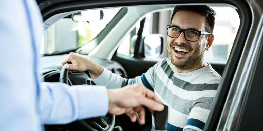 young happy man receiving new car keys in a royalty free image 1591373142 1024x512 2004b264