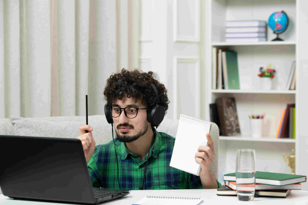 student online cute young guy studying computer glasses green shirt holding pen notepad 1 1 2 b92e0d0b